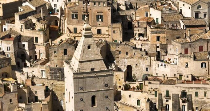 Closeup Of Matera Cathedral Tower With Matera City In Basilicata, Italy. - aerial shot