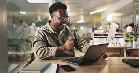 Black man, laptop and celebration at night in office for goal, deal or deadline at media company....