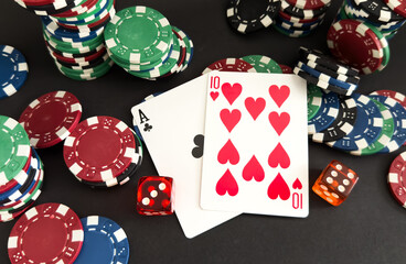  red dice, cards and poker chips, on a black background 