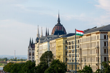 Vista di alcuni edifici sul Danubio, tra i quali il parlamento di Budapest, con la bandiera...