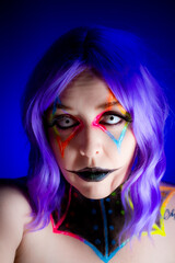 Portrait of a model wearing clown makeup with fluorescent eyewear