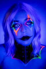 Portrait of a model wearing clown makeup with fluorescent eyewear