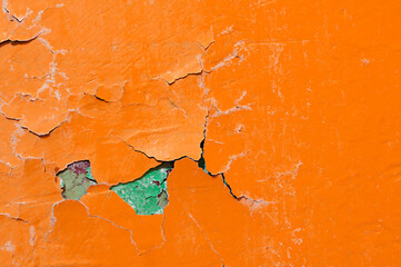 Texture background of bright orange peeling paint, colorful and bright peeling paint of orange...