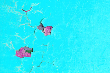 Texture background of bright turquoise peeling paint on the old rough surface, turquoise flaked...