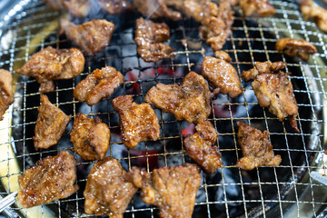 grilling the marinated pork ribs on the charcoal