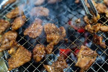 grilling the marinated pork ribs on the charcoal