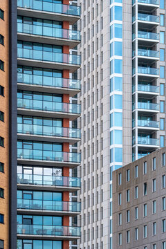 A collection of modern high-rise residential buildings with sleek designs and glass facades, creating an impressive urban skyline during daylight in Rotterdam