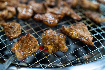 grilling the marinated pork ribs on the charcoal