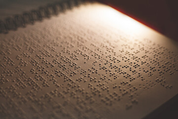 a Braille book in the dark for blind and visually impaired people