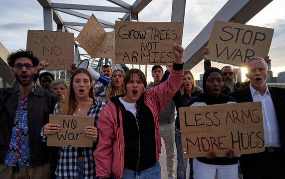 Multiethnic group of people united, looking at the camera with rage, rallying together against global wars and advocating for peace, love, and the abolition of armies.