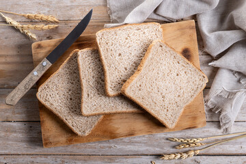 Healthy wholemeal bread slices on wooden table. Top view