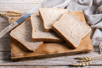 Healthy wholemeal bread slices on wooden table
