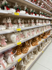 A retail display of Christmas-themed decorations including wooden ornaments, reindeer, Christmas...