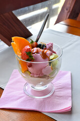 Colorful cup with ice cream and fruit