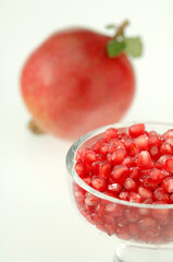 one full Pomegranate with seeds in cup