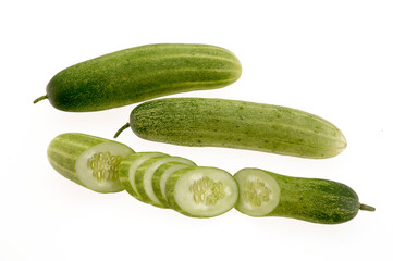 full cucumber with slices on white background