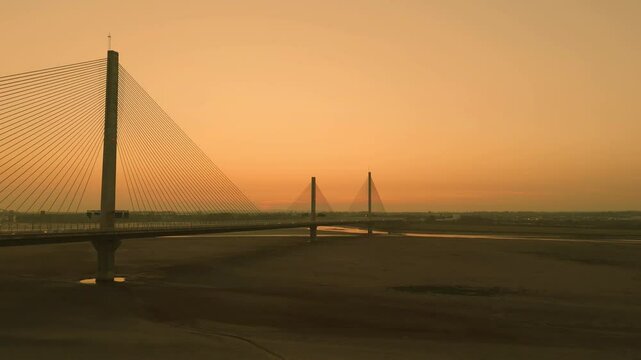 Liverpool, Merseyside, UK, September 18, 2024; aerial orbit clip of the Mersey Gateway toll bridge with stunning sun set over the River Mersey, Liverpool, UK.