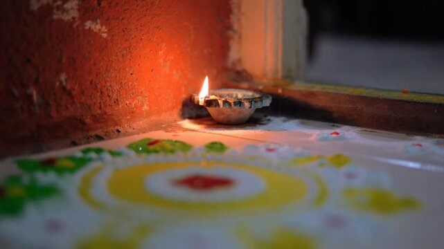 diwali diya and rangoli, focus shift from diya to rangoli. 