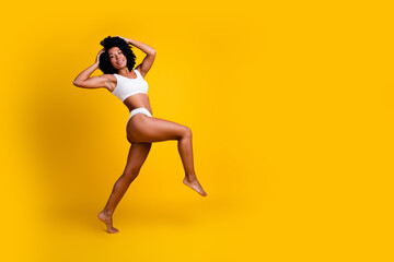 Studio no retouch photo of sensual shiny lady dressed lingerie enjoying girls power blank space isolated yellow color background