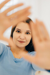 Fototapeta premium A woman in a white shirt and jeans showing a stylish and understated look. The light background and natural pose give the shot a modern feel.