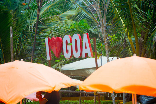 beach side shacks during day with I love Goa sign, umbrellas and chairs for tourists to sit and enjoy food drinks on vagator, anjuna, calangute beach
