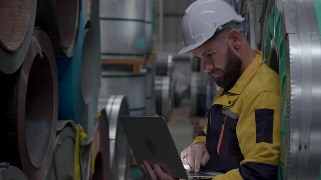 engineer manager storehouse using laptop computer inspecting or checking inventory products stock in warehouse factory