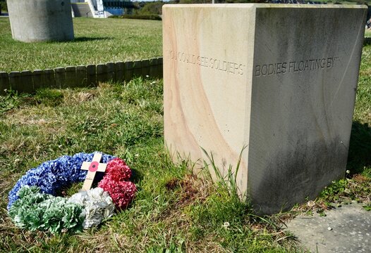 Memorial Carving with wreaths and cross at The D-Day 75 Garden.  Arromanches-les-Bains, France, July 2023. 