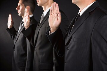 Men in suits taking oath