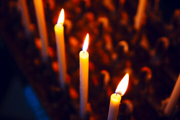   Row of lit candles casting a warm glow, creating a serene and inviting atmosphere