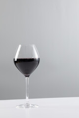 Glass of red wine and copy space on white background