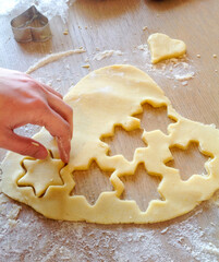 Baker making star shaped cookies from dough