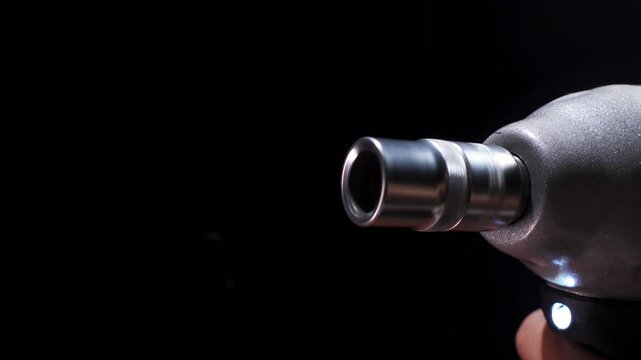 Rotating impact wrench with on black background. Electric impact driver with a rotating bit, in hand. Construction concept