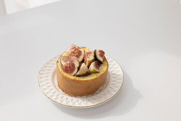 Castella cake with figs on white background.