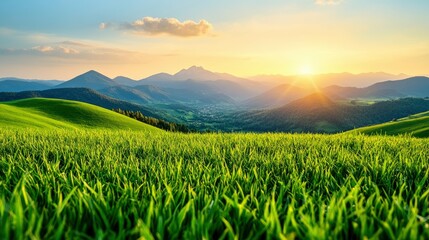 Sunset over Mountain Range with Lush Green Grass