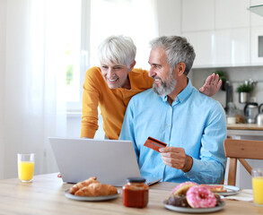 breakfast woman man senior couple home laptop credit card payment purchase online shopping customer shop buy sale website ecommerce online