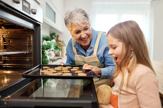 grandmother oven kitchen granddaughter baking family child bonding homemade cookie togetherness happiness cooking tradition gir