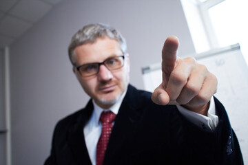 Businessman sitting at the table in the office and working
