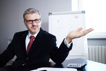 Businessman sitting at the table in the office and working