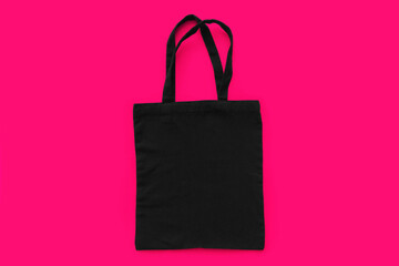 Black cotton, canvas, tote, mesh bag on light pink background. Zero waste, no plastic,eco friendly shopping recycling concept. Blank mockup shopper with place for artwork or text. Flat lay, copy space