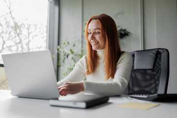 Happy Woman Working at Laptop