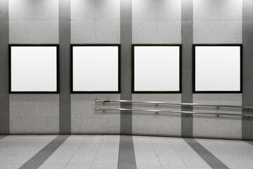 Four squares blank billboard advertising poster on a subway station platform wall. Space for text for advertising signage ideas for mockup