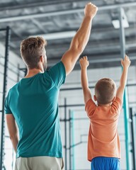 Father and son celebrating victory together in gymnasium unseen faces, united arms raised in triumph, emphasizing family bond and achievements in sports environment