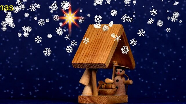 Merry Christmas, nativity scene with crib and star of Bethlehem on a turn table 
with text Merry Christmas and the German translation of it Frohe Weihnachten