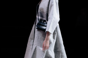 Elegant fashion details of warm gray cardigan and small leather handbag, women's fashion cloth...