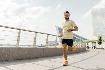 Man Jogging Along a Modern Waterfront Pathway During a Sunny Day in the City