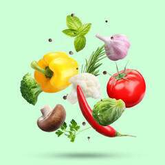 Fresh vegetables, herbs and spices in air on aquamarine color background