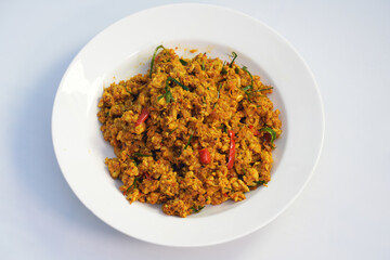 A favorite Thai dish is minced chicken stir-fried with red curry paste, called Kua Kling Kai.