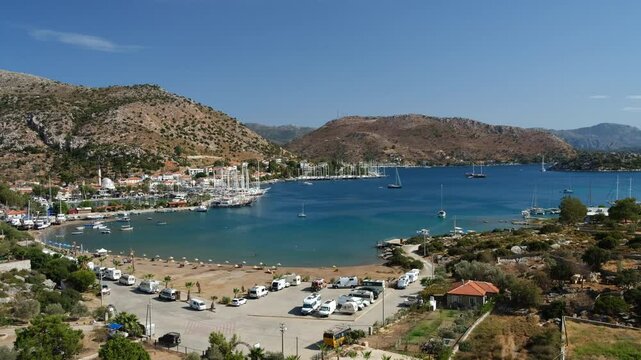 Top view of Bozburun bay. Green island and gulet boats. Cosy holiday village in mediterranean Turkey. Marmaris district, Mugla province, Turkey - 4k video
