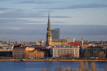 Fototapeta premium Riga, Latvia city skyline in late 2024 with could and warm light of river Daugava and buildings in city center and old town 