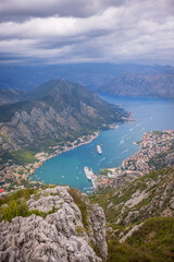 Fototapeta premium View of the Bay of Kotor, Montenegro, from a high mountain road with winding switchbacks. The scenic panorama includes the towns of Kotor and Tivat, and the Adriatic Sea.